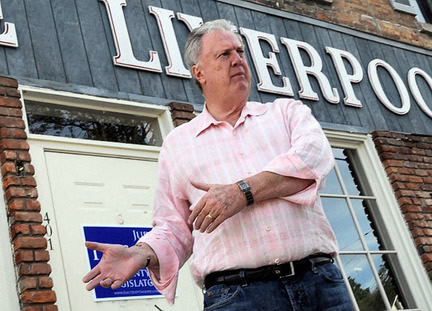 Jay Bernhardt stands in front of the Olde Liverpool Shoppe, which he plans to convert to apartments and offices.
