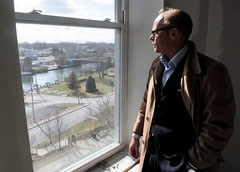 Joachim Ohlin, director of hospitality of the Hotel Clarence, in Seneca Falls, looks out one of the fourth floor rooms overlooking downtown. The hotel is scheduled to open in June.